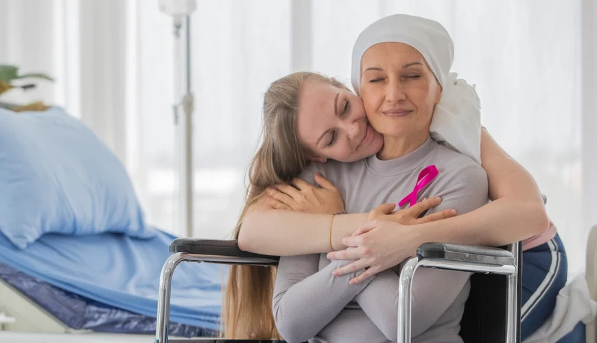 A touching scene of a woman in a wheelchair embracing her mother with love and care.