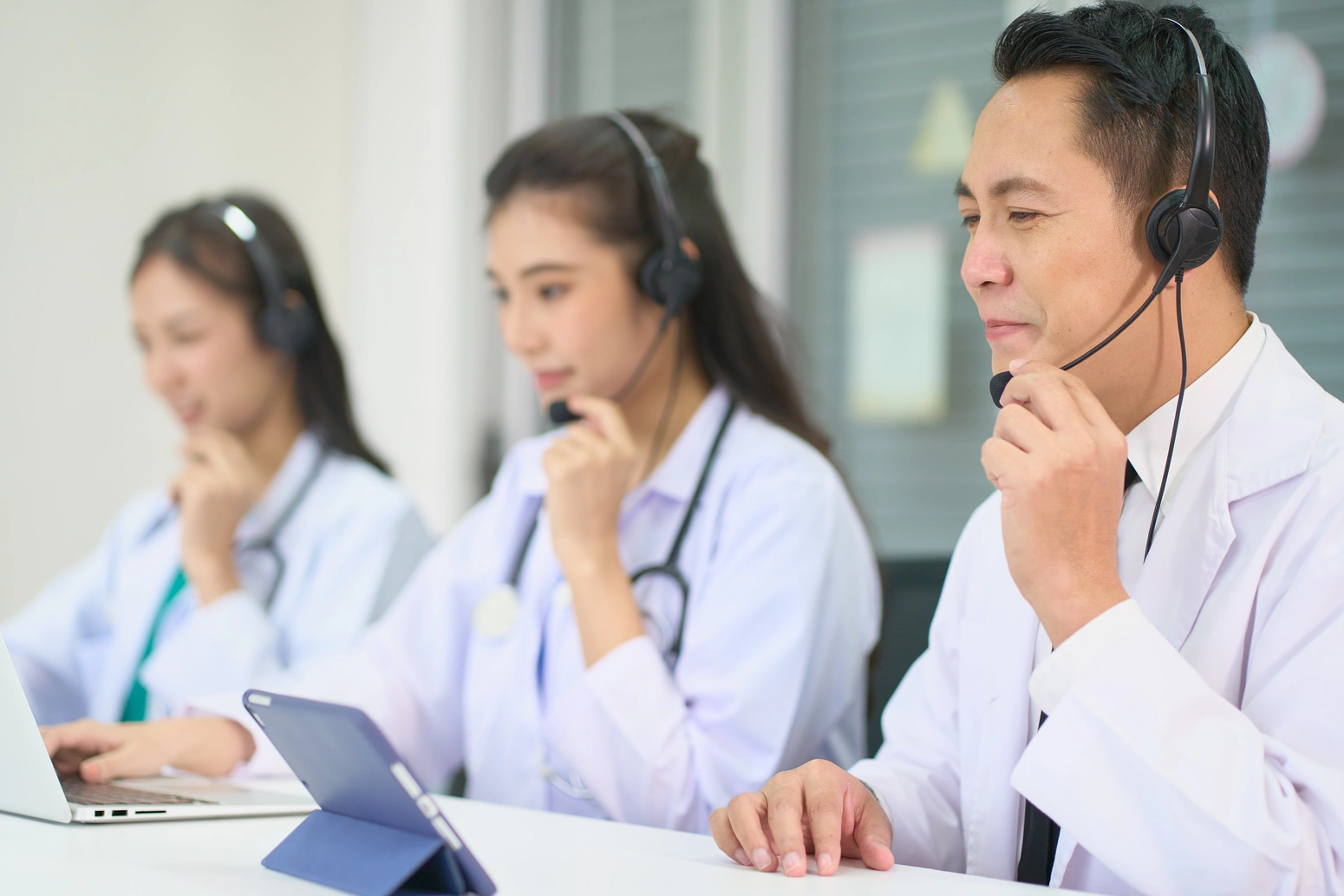 Person holding smartphone with doctor on screen for virtual medical consultation.