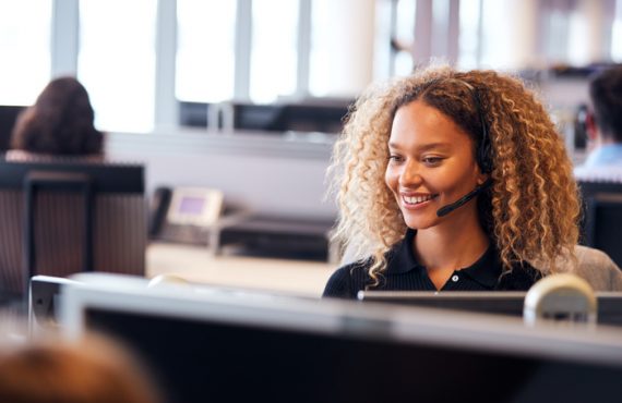 Young female medical answering service operator talking to a patient on call.